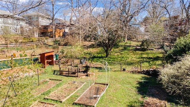 view of yard featuring a vegetable garden and fence