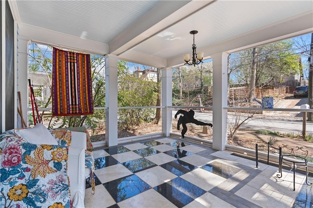 sunroom with a notable chandelier