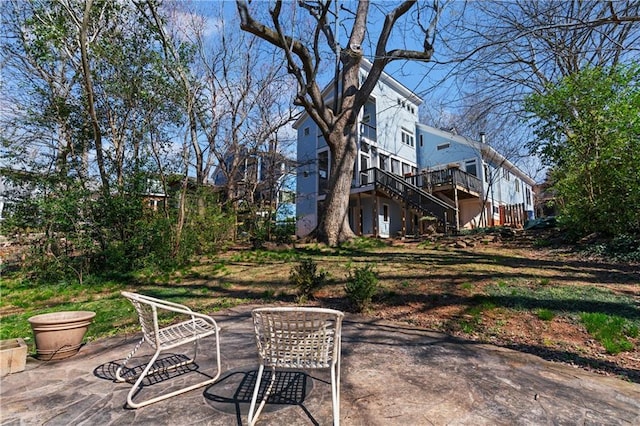 view of patio with stairs and a deck