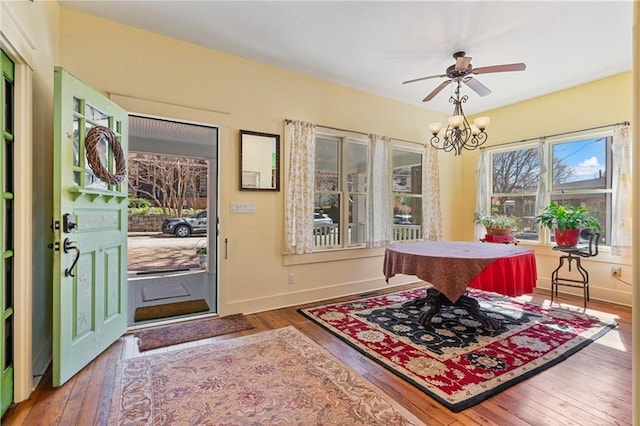 entryway featuring a chandelier, baseboards, and hardwood / wood-style floors