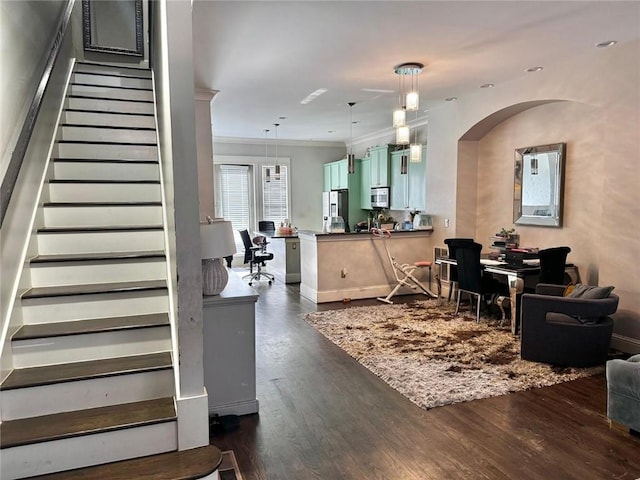 interior space with hardwood / wood-style floors and ornamental molding