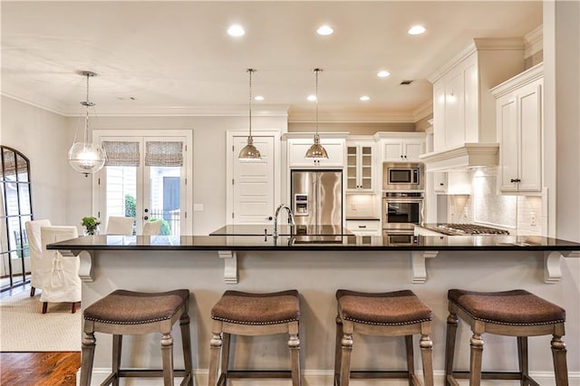 kitchen with stainless steel appliances, decorative backsplash, white cabinets, french doors, and dark countertops