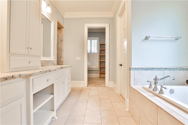 bathroom with baseboards, vanity, crown molding, and a garden tub