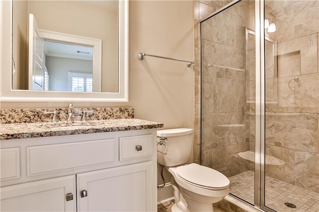 full bathroom featuring vanity, a shower stall, toilet, and visible vents