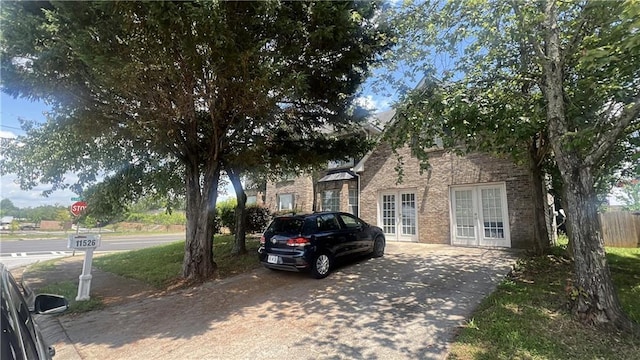 11526 Registry Blvd, Hampton, GA 30228 - view of front of home with french doors, brick siding, and driveway