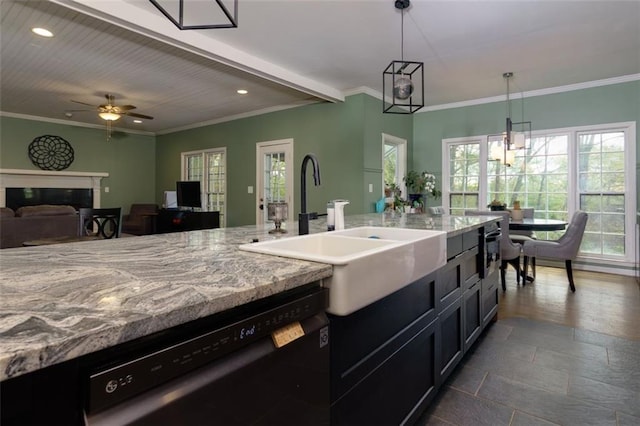 kitchen with recessed lighting, light stone counters, black dishwasher, and a sink