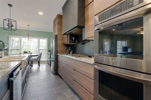 kitchen featuring recessed lighting, backsplash, crown molding, pendant lighting, and appliances with stainless steel finishes