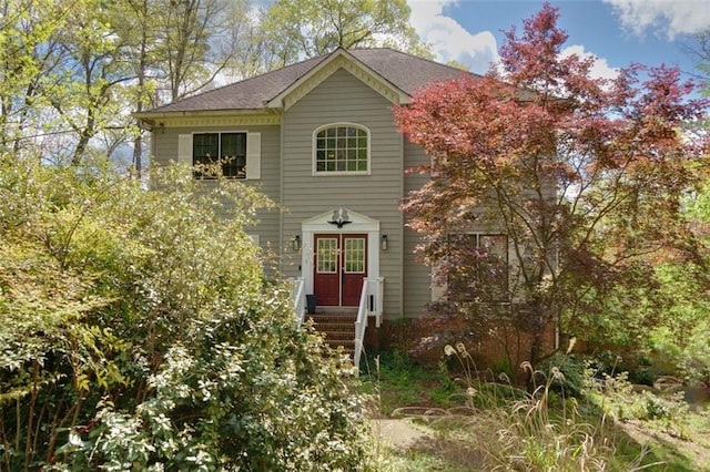 traditional home with a shingled roof