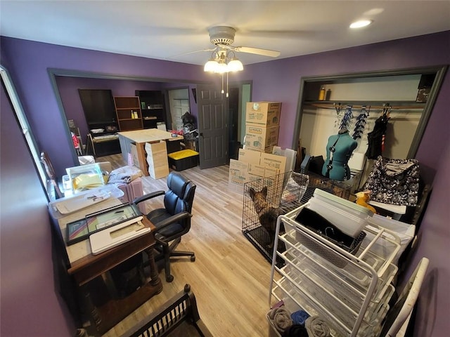 office space with a ceiling fan and light wood finished floors