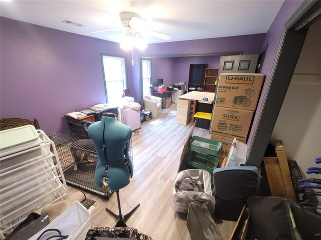 interior space with visible vents, wood finished floors, and a ceiling fan