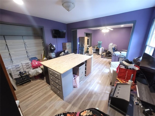 home office with a ceiling fan and light wood finished floors