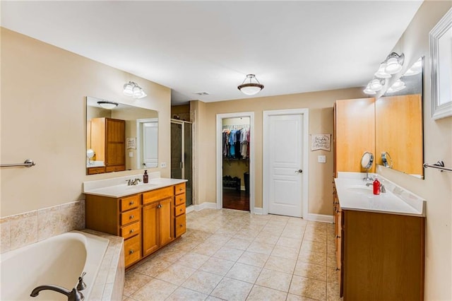 bathroom with vanity, tile patterned floors, and shower with separate bathtub