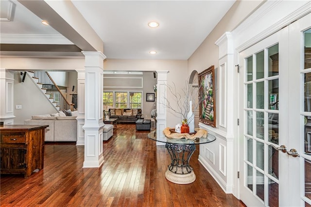 entrance foyer with decorative columns, crown molding, french doors, and dark hardwood / wood-style flooring