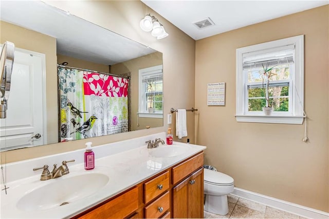 bathroom featuring vanity, toilet, tile patterned floors, and curtained shower