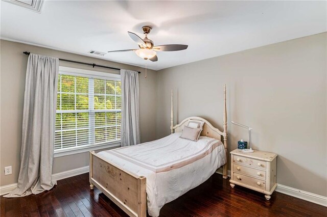 bedroom with dark hardwood / wood-style floors and ceiling fan