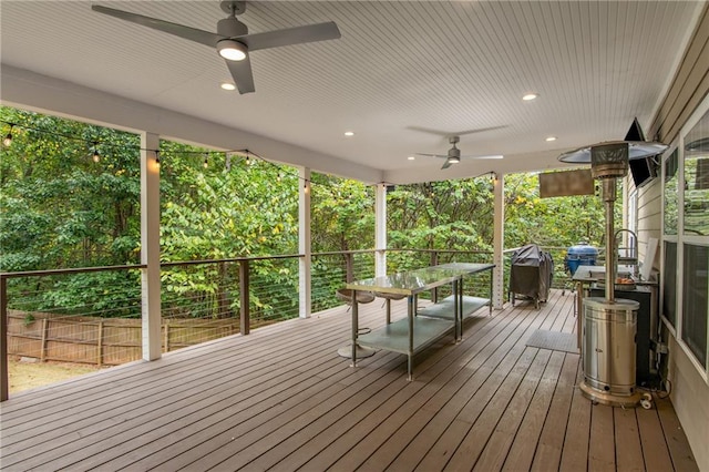 wooden terrace featuring area for grilling and ceiling fan