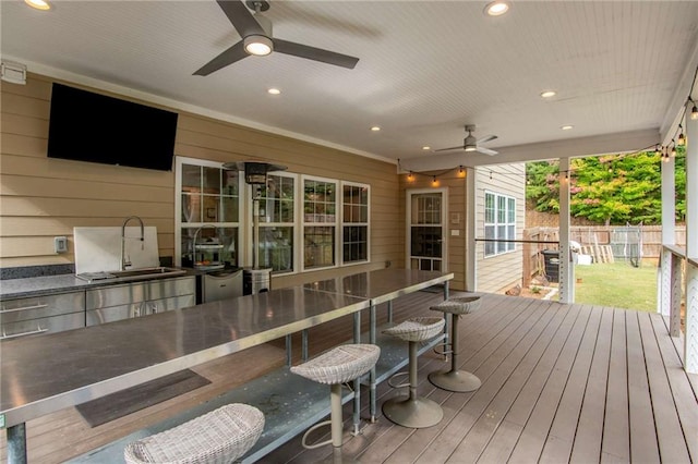 wooden terrace with ceiling fan and sink