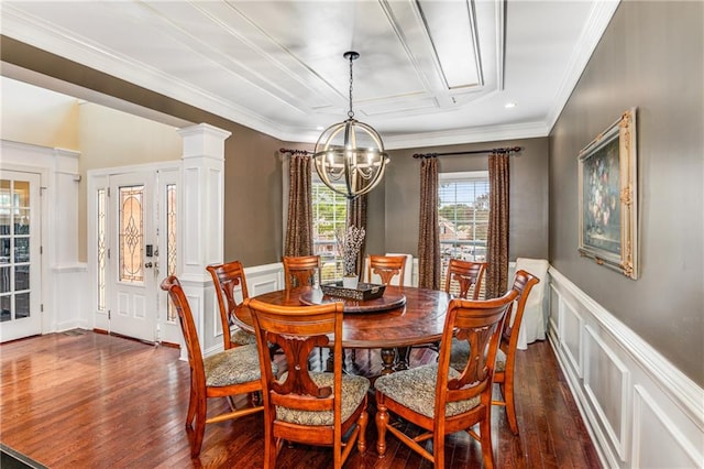 dining space featuring ornamental molding, a chandelier, ornate columns, and dark hardwood / wood-style flooring