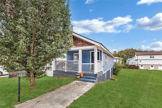 view of front of home with a front lawn and a porch