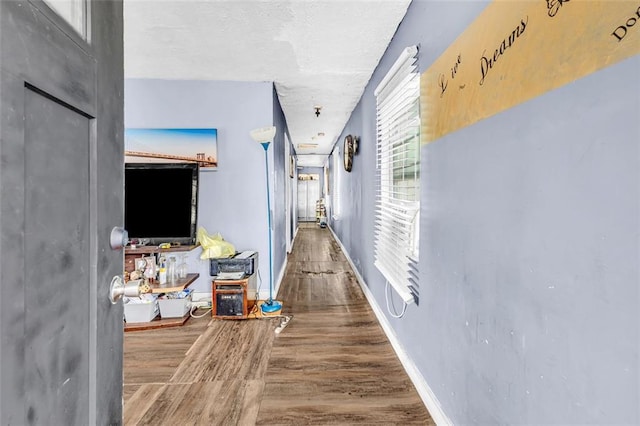 hallway with hardwood / wood-style flooring