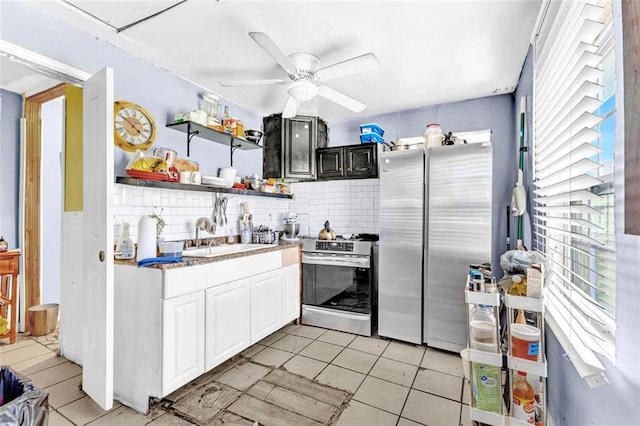 kitchen with sink, appliances with stainless steel finishes, ceiling fan, backsplash, and white cabinets