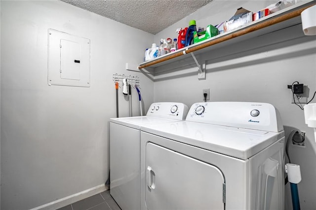 laundry room featuring independent washer and dryer, electric panel, tile patterned flooring, and a textured ceiling