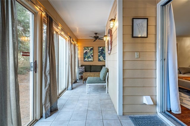 unfurnished sunroom with ceiling fan