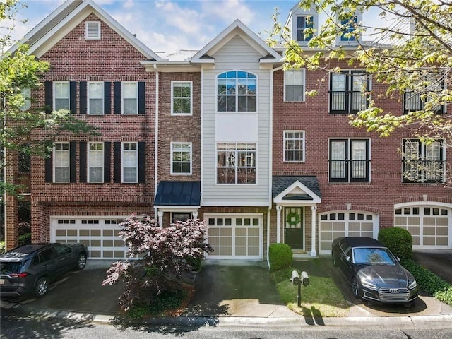 view of front of home with an attached garage and brick siding