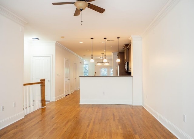 unfurnished living room with ceiling fan, light wood finished floors, and ornamental molding