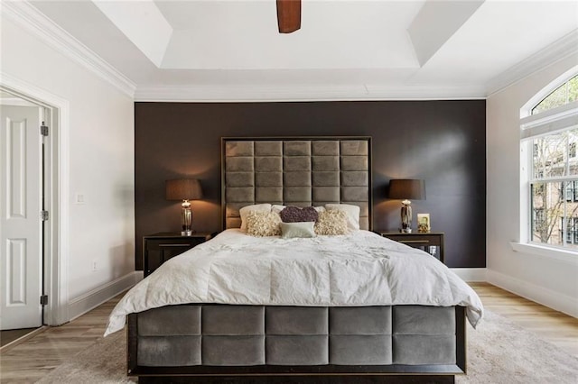 bedroom featuring wood finished floors, crown molding, and a ceiling fan