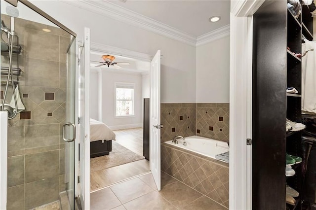 ensuite bathroom with ornamental molding, tile patterned flooring, a shower stall, a garden tub, and recessed lighting