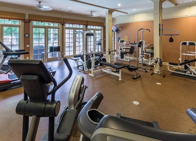 exercise room with decorative columns and recessed lighting
