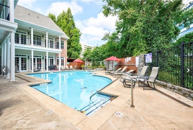 community pool featuring a patio and french doors