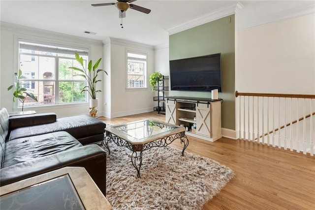 living area with wood finished floors, ceiling fan, and crown molding