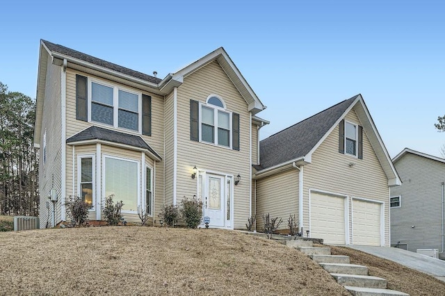 view of front facade featuring cooling unit and a garage