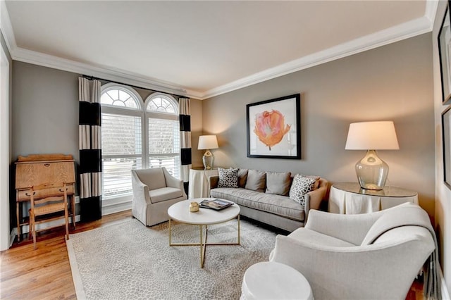 living room featuring light wood finished floors and ornamental molding