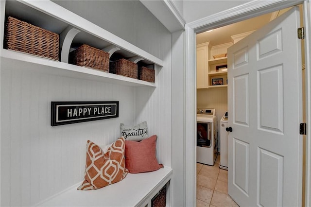 mudroom featuring light tile patterned floors and separate washer and dryer