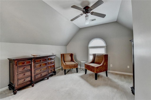 living area with lofted ceiling, light carpet, a ceiling fan, visible vents, and baseboards