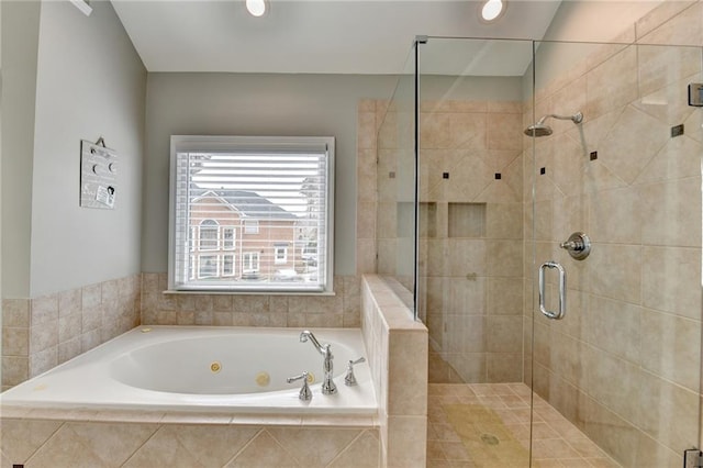 bathroom with a stall shower and a tub with jets