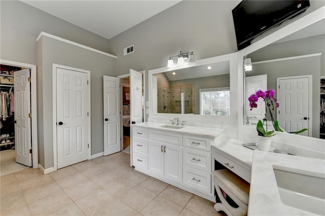 bathroom with tile patterned flooring, visible vents, a shower stall, and vanity