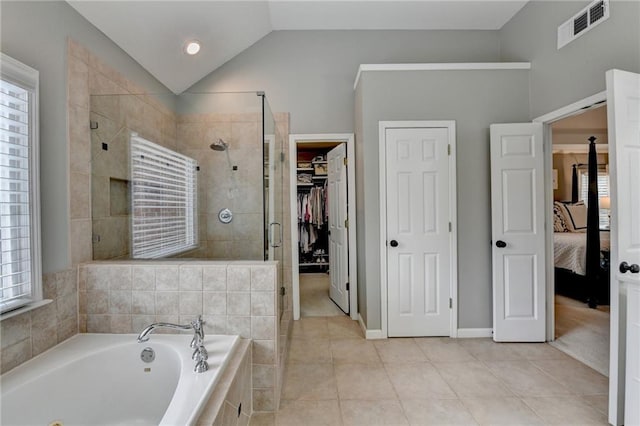 bathroom featuring a garden tub, visible vents, vaulted ceiling, tile patterned floors, and a stall shower