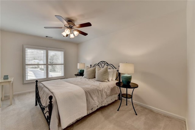 bedroom with a ceiling fan, baseboards, visible vents, and carpet flooring