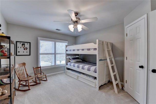 carpeted bedroom featuring visible vents, ceiling fan, and baseboards