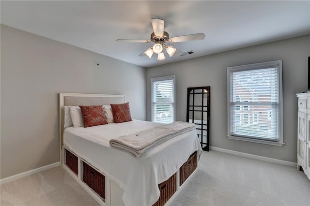 bedroom with light carpet, visible vents, and baseboards