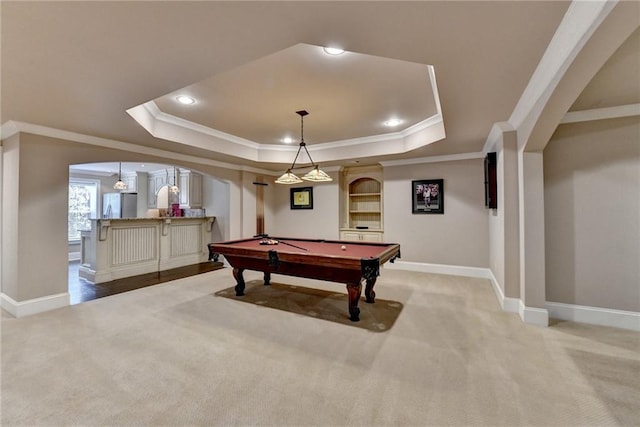 recreation room with arched walkways, recessed lighting, light colored carpet, baseboards, and a tray ceiling