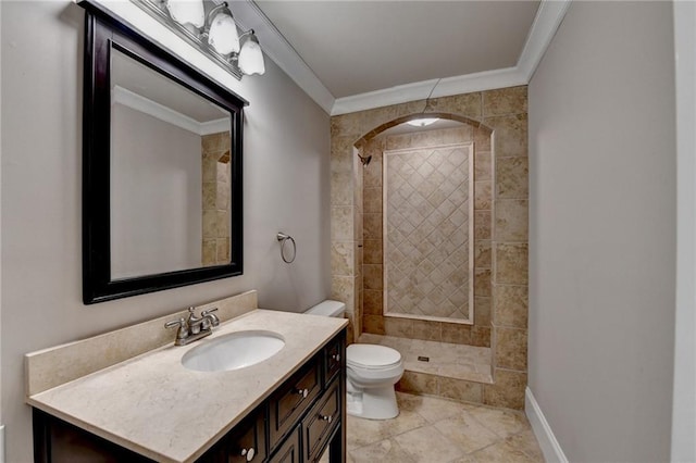 full bathroom with baseboards, toilet, ornamental molding, a tile shower, and vanity