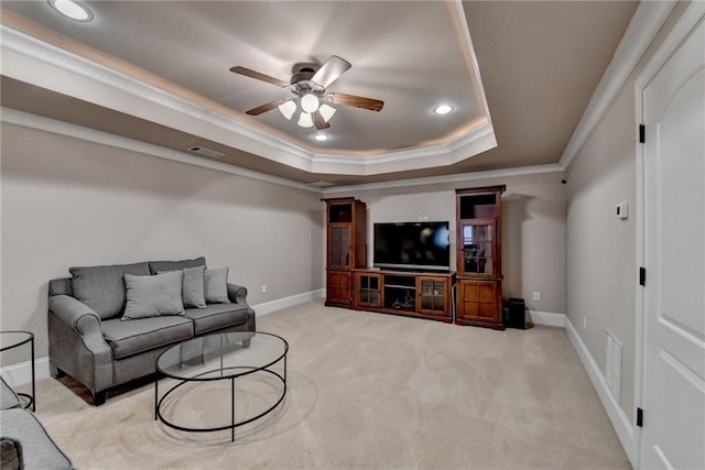 living room with carpet, crown molding, a raised ceiling, visible vents, and baseboards