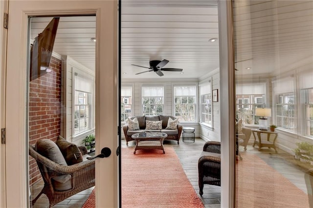 sunroom / solarium with a ceiling fan