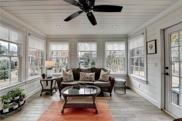 sunroom / solarium featuring wooden ceiling and a ceiling fan