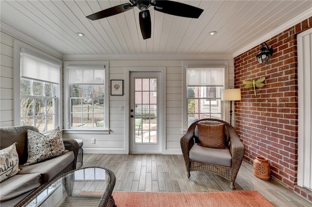 sunroom featuring wooden ceiling and ceiling fan